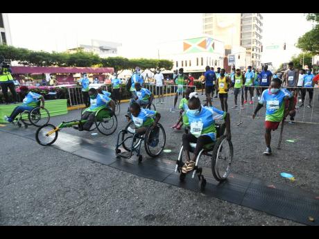 Racers at the start of the Sagicor SIGMA Corporate Run on Knutsford Boulevard, St Andrew, yesterday.