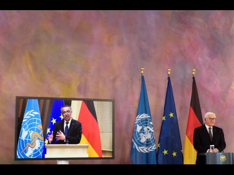 German President Frank-Walter Steinmeier (right) and Director General of the World Health Organization Tedros Adhanom Ghebreyesus (on the screen) brief the media on a virtual joint news conference at Bellevue Palace in Berlin, Germany, yesterday.