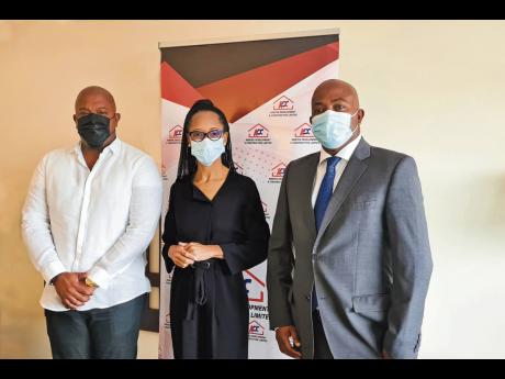 Acting General Manager of the Professional Football Jamaica Limited Arlene Martin (centre) shares lens time with Kemtech Development and Construction executives Karl Tulloch (left) and Garwin Tulloch. Kemtek recently signed on as a club sponsor of the Jama
