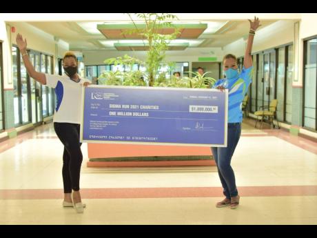 Nichole Brackett-Walters (left), group marketing and communications manager at NCB, and Alysia Moulton-White, executive director of the Sagicor Foundation, celebrate the coming together of two of Jamaica’s largest banks for a worthy cause. NCB donated $1