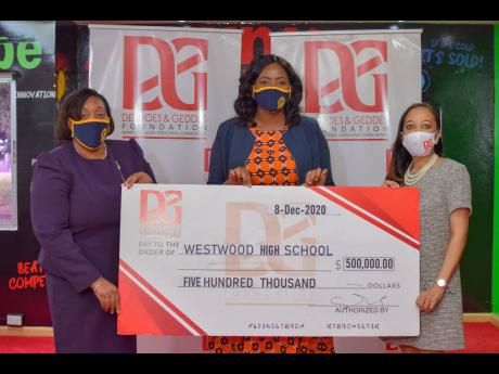 From left: Karen Francis, principal of Westwood High School, and Natalia Whyte, teacher at the school, receive a cheque valued at $500,000 from Dianne Ashton-Smith, board member of the Desnoes and Geddes (D&G) Foundation. The organisation made the donation