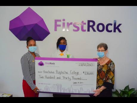 From left: Kereen Stewart, , guidance counsellor, and Jodi-Kay Thomas,  student council representative, show appreciation on behalf of Knockalva Polytechnic College as they collect a cheque for  $230,000 from Joyce Chin, chairwoman at FirstRock Foundation.