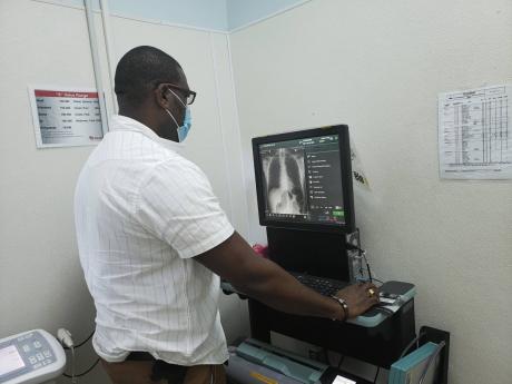 Orville Anderson, manager of Medical Imaging at Falmouth Hospital, views an image on the Picture Archiving Communication System.