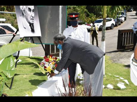 Custos of Hanover, Dr David Stair, lays a floral tribute to mark the 137th anniversary of the birth of National Hero Sir Alexander Bustamante, at his birthplace on February 24.