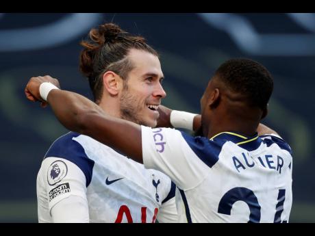 Tottenham’s Gareth Bale, (left) celebrates with Serge Aurier during an English Premier League match between Tottenham Hotspur and Burnley at the Tottenham Hotspur Stadium in London, England, yesterday. Spurs won 4-0.