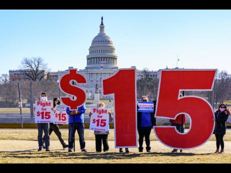 Activists appeal for a US$15 minimum wage near the Capitol in Washington on February 25. The fight is on to attach a hike in the federal minimum wage to the US$1.9-trillion COVID relief bill in the United States.