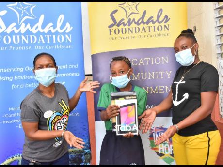 From left: Rochelle Forbes-Reid, public relations manager, Sandals Whitehouse, shares a light moment with Shantae Williams, student at Fyffes Pen Primary School in St Elizabeth, and mother, Dian Channer. The Sandals Foundation continues to distribute more 