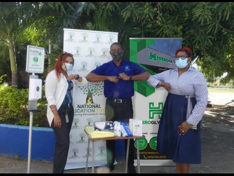 Under these masks are bright smiles in light of the PPE donation to the Central Branch All-Age School. Sharing lens in this warm moment are (from left) Shirley Moncrieffe, director of educational projects at the National Education Trust; Michael Sutherland