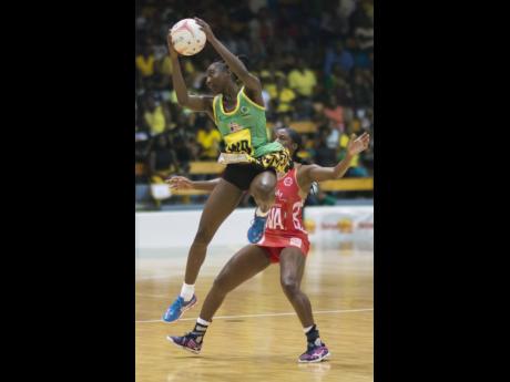 Jamaica’s Vangelee Williams (left) leaps to catch a pass over England’s Chelsea Pitman in the Sunshine Series at the National Indoor Sports Centre in October 2018.
