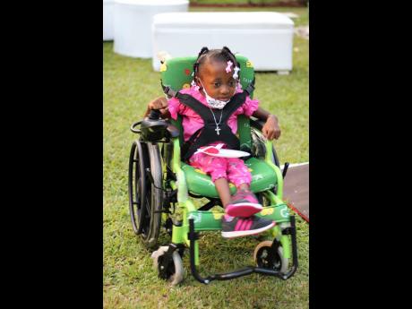 Dominique Smith quickly learnt how to operate her new, motorised chair around the garden. 