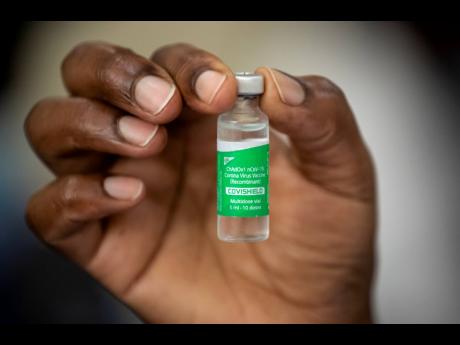 A nurse holds a vial of AstraZeneca COVID-19 vaccine manufactured by the Serum Institute of India and provided through the global COVAX initiative, at Kenyatta National Hospital in Nairobi, Kenya Friday, March 5, 2021. Urgent calls for COVID-19 vaccine fai