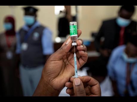 A nurse prepares to administer an AstraZeneca COVID-19 vaccine manufactured by the Serum Institute of India and provided through the global COVAX initiative, at Kenyatta National Hospital in Nairobi, Kenya Friday, March 5, 2021. Urgent calls for COVID-19 v