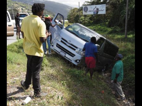 
Passers-by stop to look at a Toyota Hiace bus that spun out of control and crashed into a ditch along the Mandela Highway on Tuesday. The driver was rejoiced at having survived the scare along the busy thoroughfare. Data from the Road Safety Unit show tha