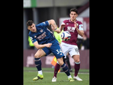 
Arsenal’s Granit Xhaka (left) and Burnley’s Ashley Westwood challenge for the ball during the English Premier League match between Burnley and Arsenal at Turf Moor stadium in Burnley, England, yesterday.