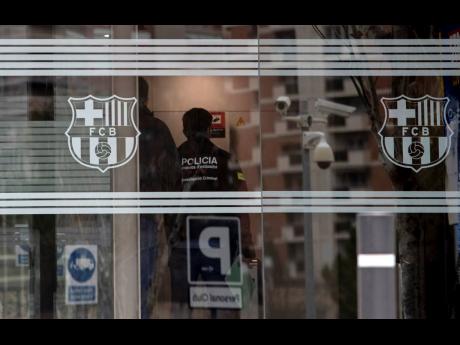 
In this file photo dated Monday, March 1, 2021, Catalan police enter FC Barcelona’s offices in Barcelona, Spain, where they detained several people in a search and seize operation.  More than 110,000 Barcelona club members will elect a new president tod