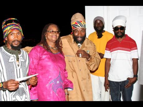 Capleton (centre), shares a light moment with his manager, Claudette Kemp, and his entourage during the 2008 launch of A St Mary Mi Come From.