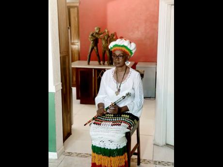 Maxine Stowe with Bunny Wailer’s Solomonic staff, which she says is for protection.