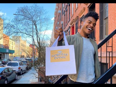 
Kumangai holds a bag promoting his company Humpday Dough in New York. 