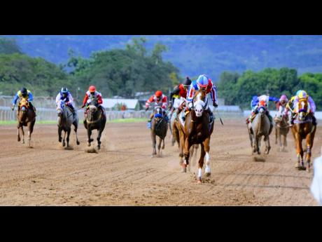 CUSTER, ridden by Shane Ellis (foreground), outpaces rivals and wins the sixth race at Caymanas Park on Sunday, March 7, 2021.