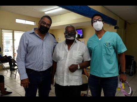 (From left) Dr Wykeham McNeill, Freddie Clarke, radiologist, and Jordan McNeill, dental surgeon, are seen at the vaccination centre at St Joseph’s Hospital in Vineyard Town, Kingston, on Saturday.