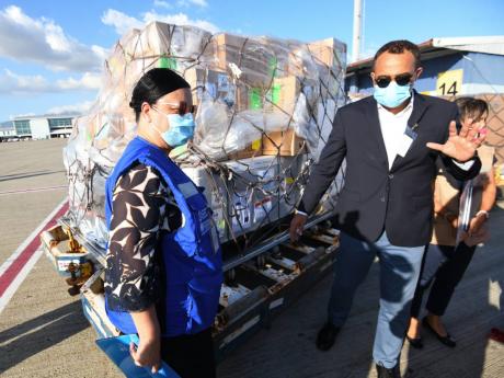 Dr Bernadette Theodore-Gandi, PAHO/WHO country representative; Health and Wellness Minister Dr Christopher Tufton; and UNICEF Jamaica Representative Mariko Kagoshima receive the island’s first shipment of AstraZeneca vaccines under the COVAX Facility at 
