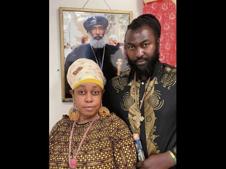 Ras Emmanuel (right) with his treasured sceptre in hand, next to his video star wife, Queen Zebulum.