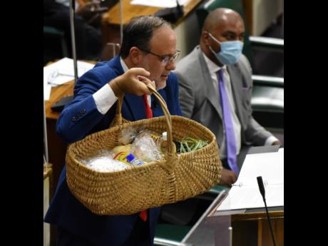 Opposition Leader Mark Golding displays what he says is a basket of food depleted by rising prices. He was making his maiden Budget Debate presentation as opposition leader. 