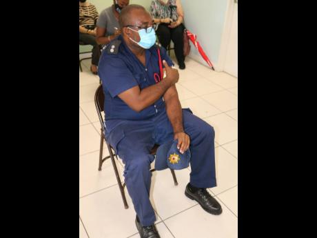 Assistant Superintendent Howard Thomas of the Jamaica Fire Brigade relaxes in the observation area after being vaccinated at The Good Samaritan Inn in Kingston on Wednesday.