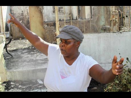Sixty-six-year-old Icilda Sheckles of Bailey’s Ave, May Pen, Clarendon, explains how quickly the fire engulfed their house last Saturday, destroying their three-bedroom house and its content. 