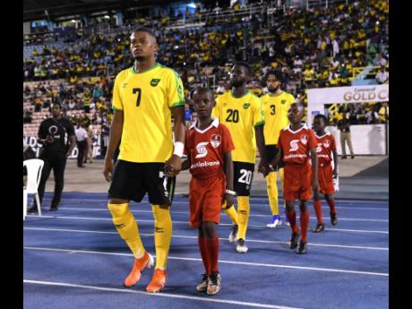 Leon Bailey and other members of Jamaica’s national senior team make their way on to the field ahead of their Concacaf Gold Cup match against Honduras at the National Stadium on June 18, 2019.
