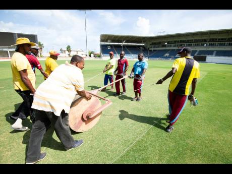 Groundsmen prepare a pitch at Sabina Park ahead of a Test match between the West Indies and India in August 2019.