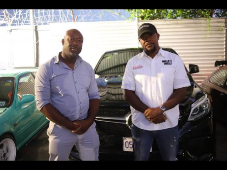 Kevin Rhoden (left), owner of Kevin and Robert Autocare, stands beside his friend Andrew Lee-Sing