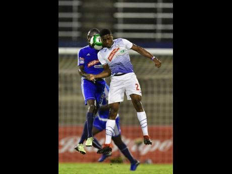 
Mount Pleasant’s Xavion Virgo (left) and Emelio Rousseau of Portmore United try to head the ball during a Jamaica Premier League semi-final at the National Stadium on Monday, April 15, 2019.