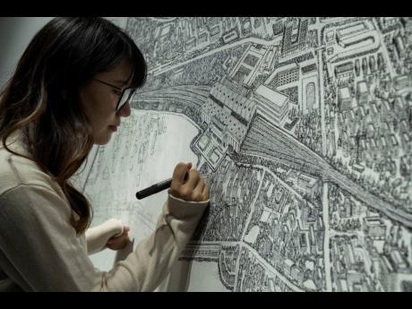 
Chinese artist Yang Qian using dots to recreate an aerial view of Wuhan, China, under lockdown at her studio in Wuhan in central China’s Hubei province.