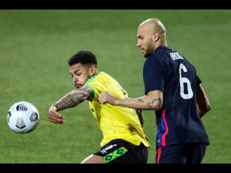 
USA’s John Brooks duels for the ball with Jamaica’s Andre Gray (left) during their international friendly 
match at SC Wiener 
Neustadt stadium 
in Wiener 
Neustadt, Austria, 
yesterday.