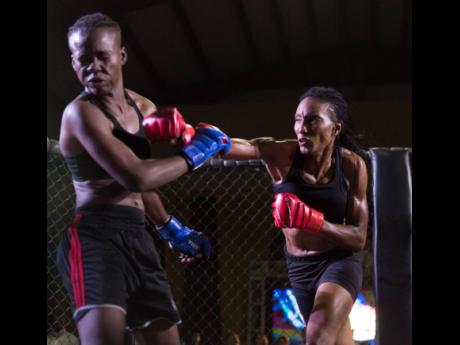 Local boxer Lisa Frazer (right), seen here in a mixed martial arts fight against Shanice Blake, qualified to represent Jamaica in Olympic qualifiers after winning at the Jamaica Boxing Board's National Championships in 2020. 