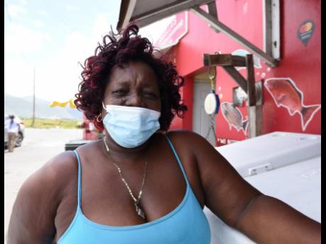 Julett, a fish vendor at the Rae Town Fishing Village in Central Kingston, says the weekend curfews are hurting the business. 