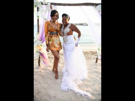 Queenie’s NashWear wedding dress was made in less than three days. The happy bride poses with friend and musical collaborator, D’Angel.