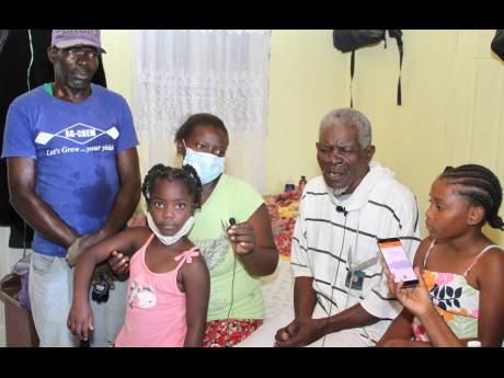 Lionel Johnson is surrounded by his son Clifford, daughter Evadney and granddaughters Shereece Dixon and Charlette Thomas.