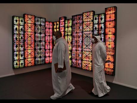 People visit Saudi artist Rashed Al Shashai’s work titled Brand 14, Light Boxes, Plastic Cases, at the 14th edition of Art Dubai at Dubai International Financial Centre, DIFC, which features 50 galleries from 31 countries with a focus on modern and conte