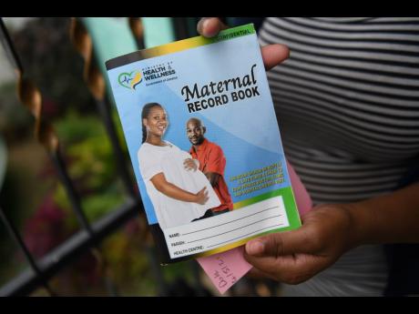 Mrs Bartley displays her maternal record book received from the University Hospital of the West Indies. She alleges that her newborn died because of the negligence of hospital staff during childbirth. 