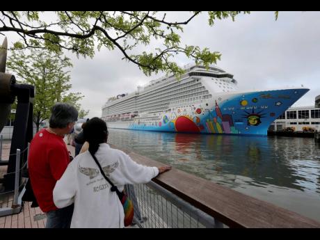 People pause to look at Norwegian Cruise Line’s ship, ‘Norwegian Breakaway’, on the Hudson River in New York, in this May 8, 2013 file photo.