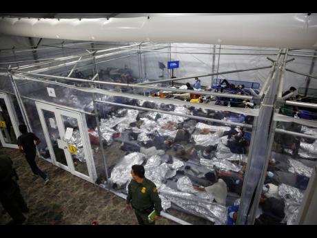 In this March 30, 2021 photo, minors inside a pod at the Donna Department of Homeland Security holding facility, the main detention centre for unaccompanied children in the Rio Grande Valley run by United States Customs and Border Protection, in Donna, Tex