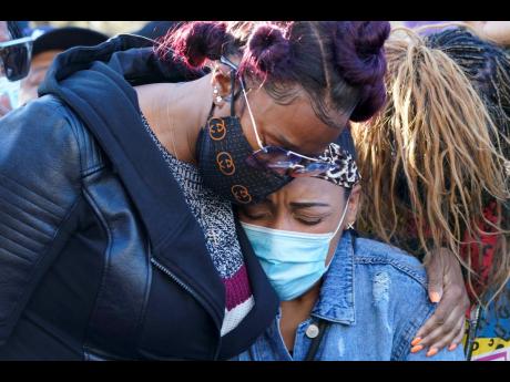 DMX’s ex-wife, Tashera Simmons (left), and his fiancée, Desiree Lindstrom, embrace outside of the White Plains Hospital, where the rapper remains on life support. 