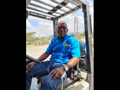 Alphonso Grennell sitting in his forklift that is used to teach students. 