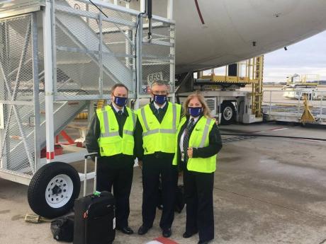From left: FedEx Captains Trey Hollingsworth, Tom Gregory  and Muriel Zarlingo (right) share lens time on the tarmac in Grand Rapid, Michigan, where they went to pick up the first shipment of COVID-19 vaccines to be delivered in the United States late last