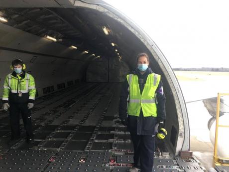 Two ground handlers getting ready to pack the first shipment of COVID-19 vaccines on to an A300 600 Airbus in Grand Rapid, Michigan, late last year.