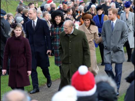 Britain's Prince Philip (centre), walks with Lady Louise Windsor (left), Prince William and Kate, Duchess of Cambridge, Prince Harry (right), and Meghan Markle, as they arrive to attend the Christmas Day morning church service at St Mary Magdalene Church i