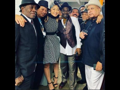 Trinity (left), with London crew members, including Dennis Alcapone, Winston Francis and female Japanese sax player, Megumi.