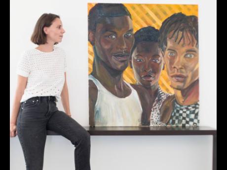 French artist Marguerite Wibaux next to her oil on canvas painting ‘One Love’ for which she recruited Saint International models (pictured from left) Val Haughton, Sabrina Nugent and Kristoff Taylor.